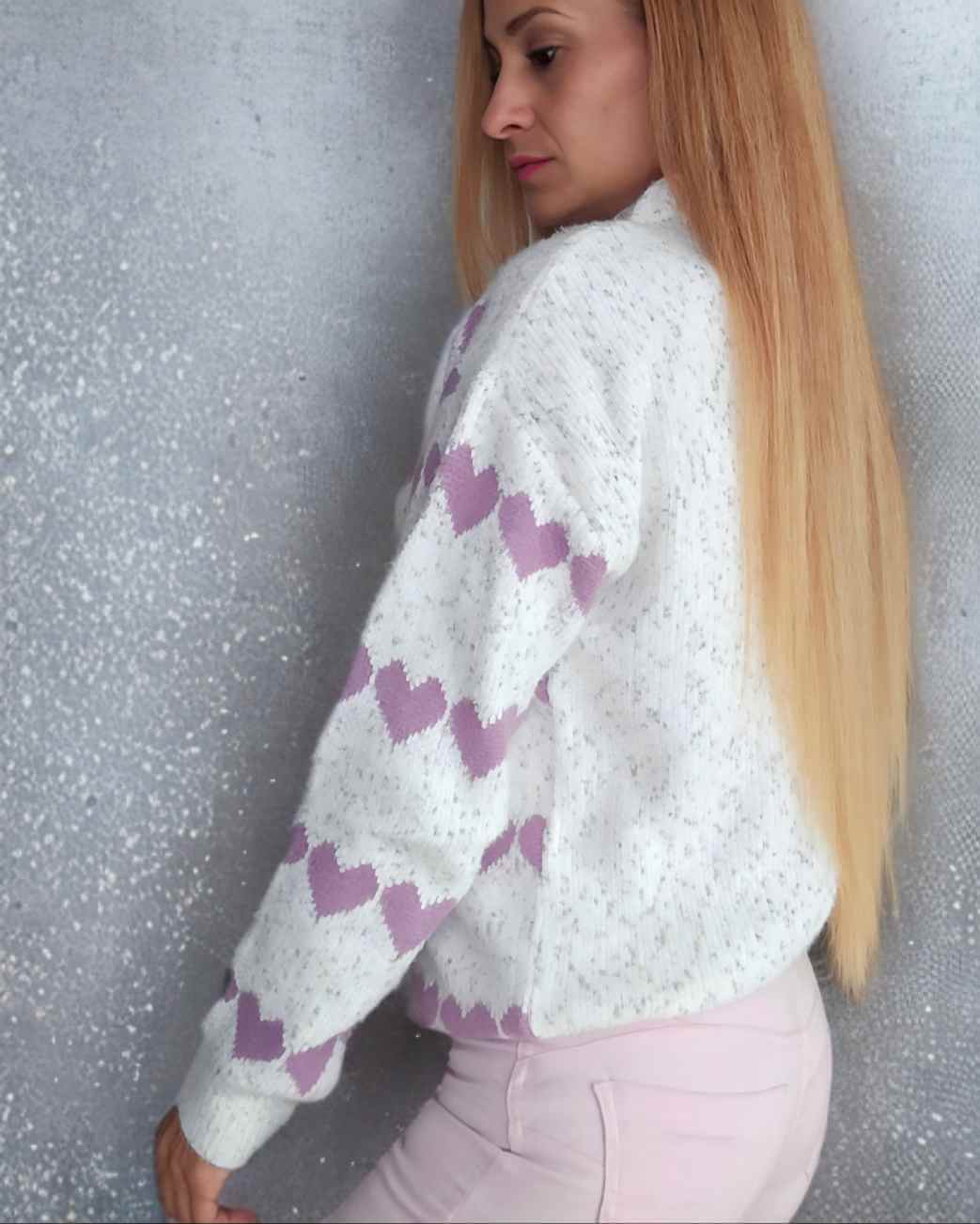 Pullover Jersey Cuori BlancoEste jersey suave cuenta con un diseño de cenefas con corazones en contraste, presentando un estilo único y femenino. Con corazones lila y un fondo jaspeado en tonos blanco, gris y rosa, este jersey es ideal para añadir un toqu