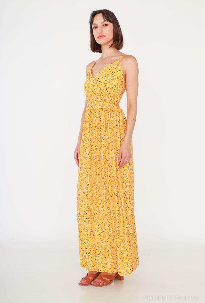 Vestido Glorie AmarilloVestido Largo Cruzado Glorie El Vestido Glorie Amarillo es una prenda elegante y versátil con un escote cruzado y un estampado de pequeñas flores que lo hacen único. Sus tirantes regulables ofrecen un ajuste perfecto y cómodo. Ideal
