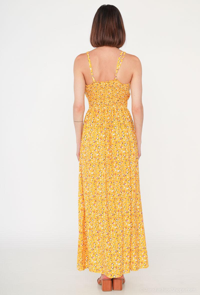 Vestido Glorie AmarilloVestido Largo Cruzado Glorie El Vestido Glorie Amarillo es una prenda elegante y versátil con un escote cruzado y un estampado de pequeñas flores que lo hacen único. Sus tirantes regulables ofrecen un ajuste perfecto y cómodo. Ideal