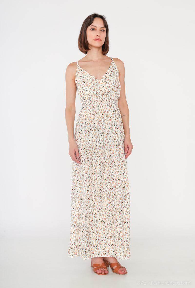 Vestido Glorie CremaVestido Largo Cruzado Glorie El Vestido Glorie Amarillo es una prenda elegante y versátil con un escote cruzado y un estampado de pequeñas flores que lo hacen único. Sus tirantes regulables ofrecen un ajuste perfecto y cómodo. Ideal pa