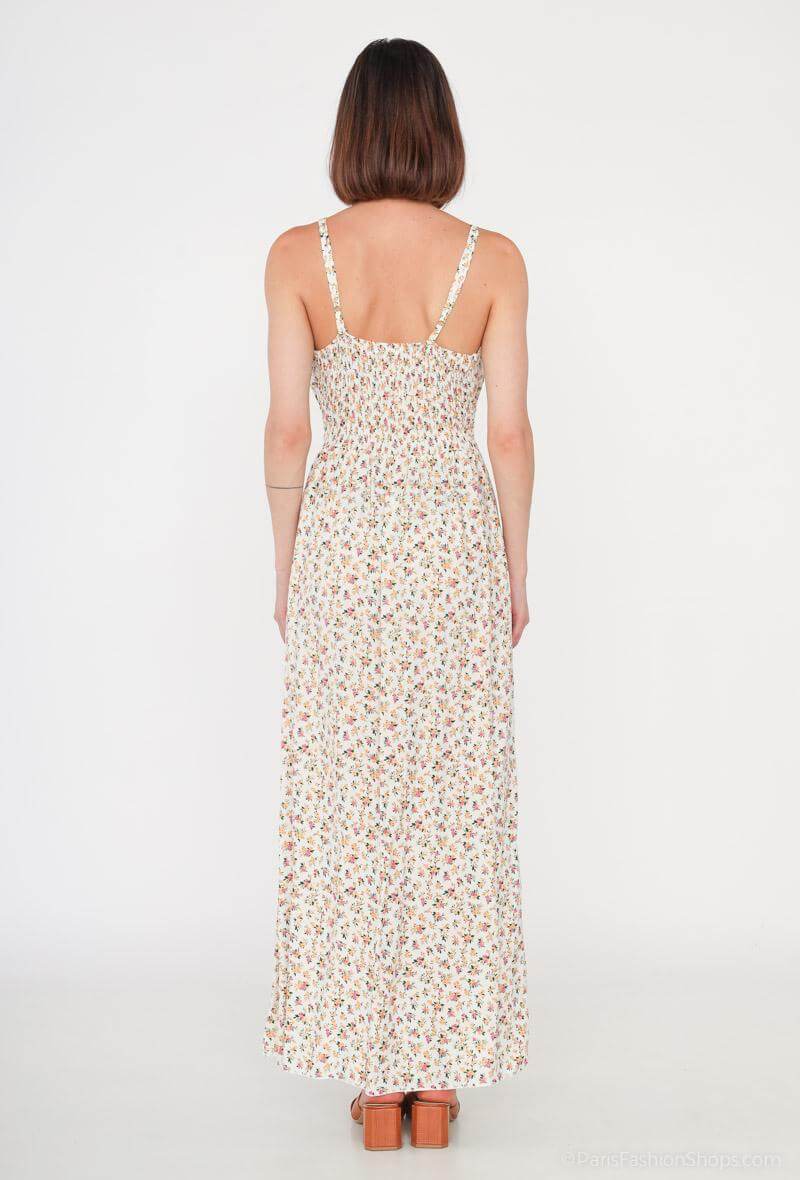 Vestido Glorie CremaVestido Largo Cruzado Glorie El Vestido Glorie Amarillo es una prenda elegante y versátil con un escote cruzado y un estampado de pequeñas flores que lo hacen único. Sus tirantes regulables ofrecen un ajuste perfecto y cómodo. Ideal pa